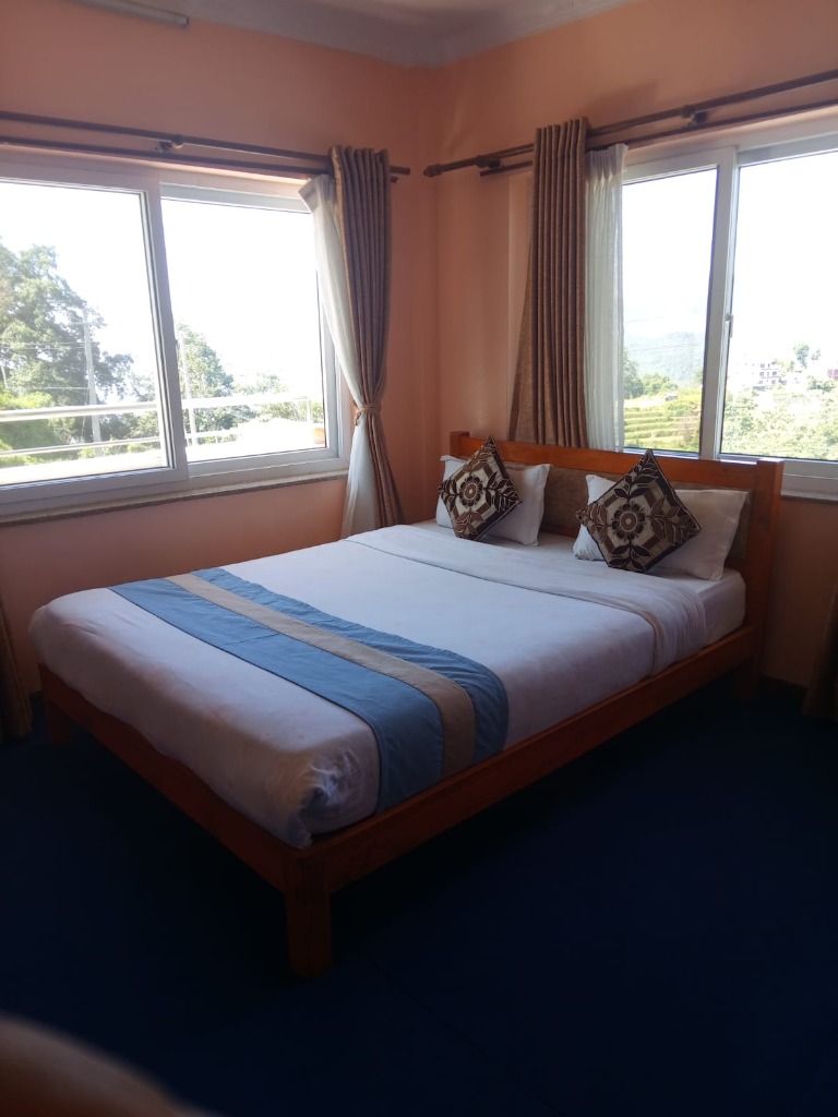 Hotel Road Side comfortable bedroom with scenic mountain windows